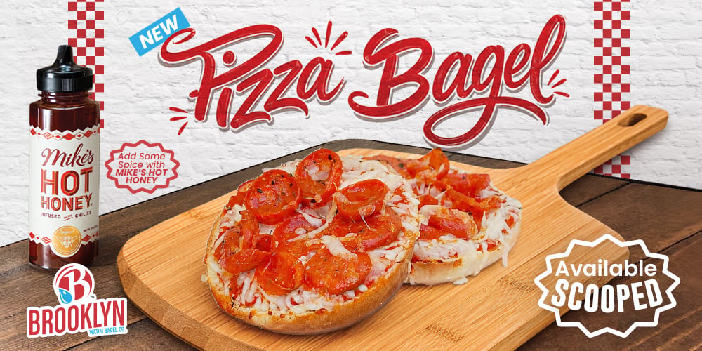 New pizza bagel topped with pepperoni on a wooden board, with Mike's Hot Honey bottle and Brooklyn Water Bagel Co branding visible.