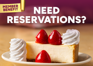 Promotional banner reading 'Need Reservations?' over a strawberry cheesecake with whipped cream on a plate, hinting at member benefits.